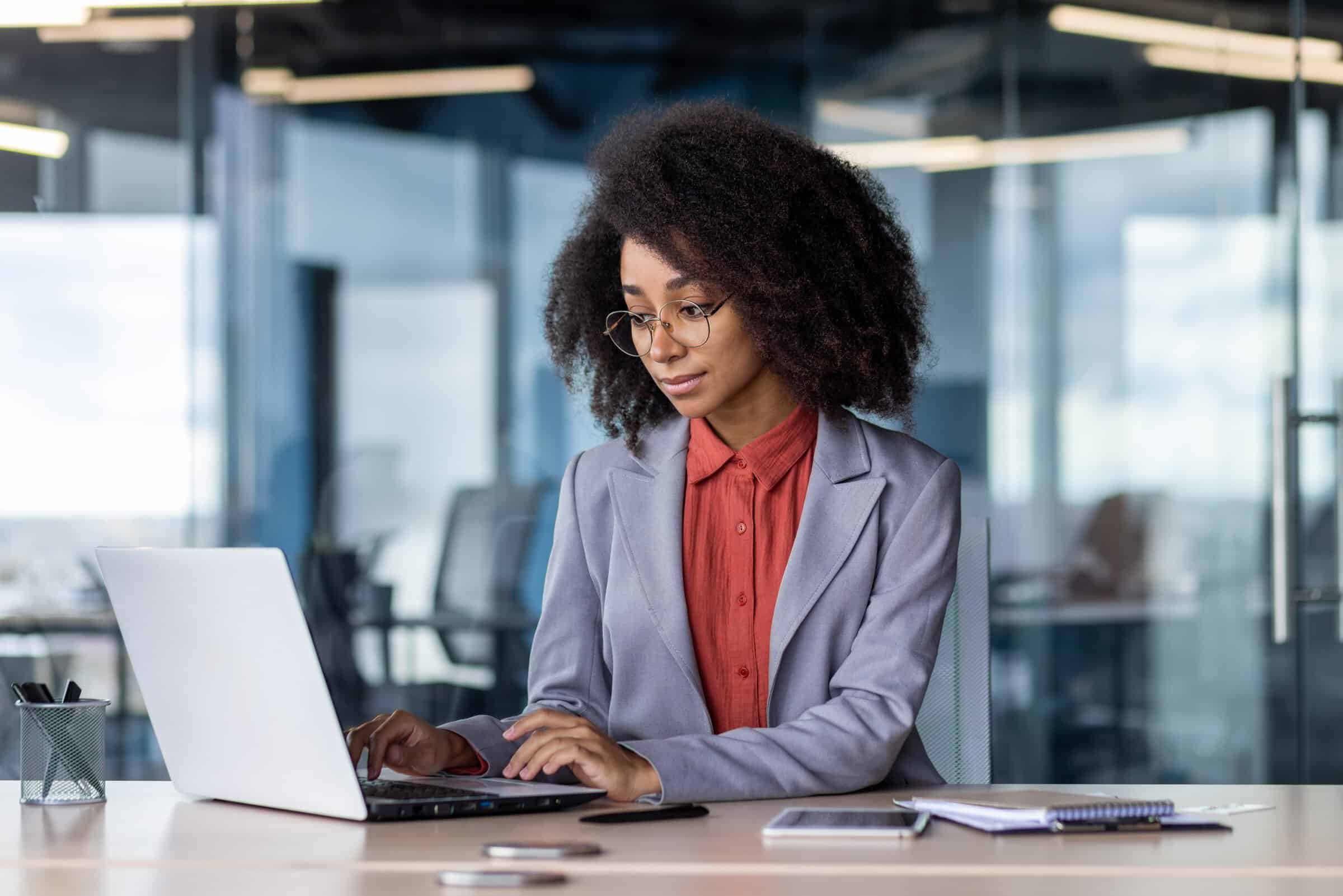Photo of a woman working at her computer.