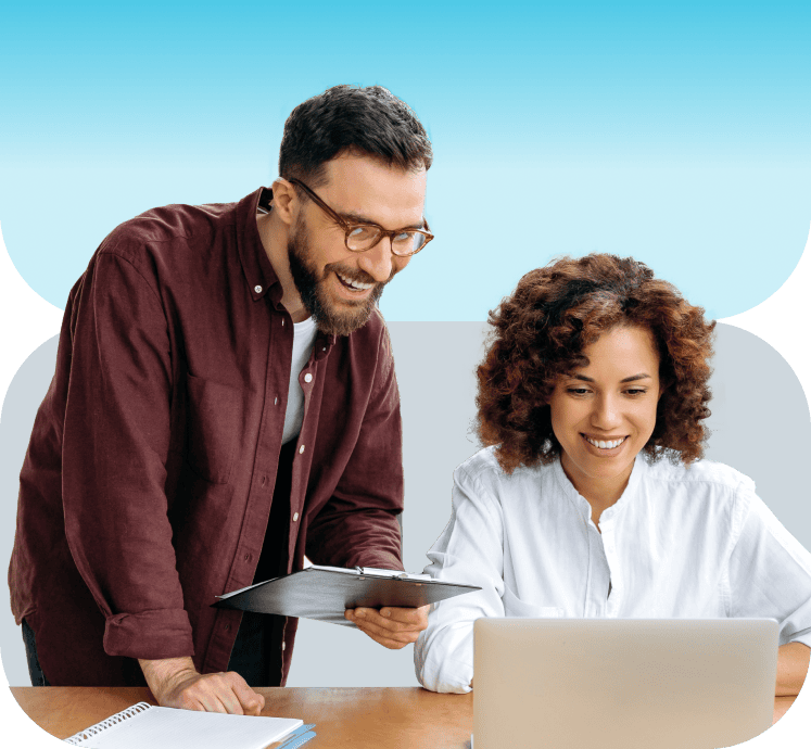 Two colleagues working on computer together
