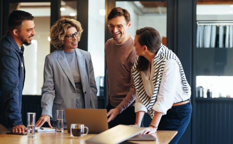 Photo of a team working together in an office space.