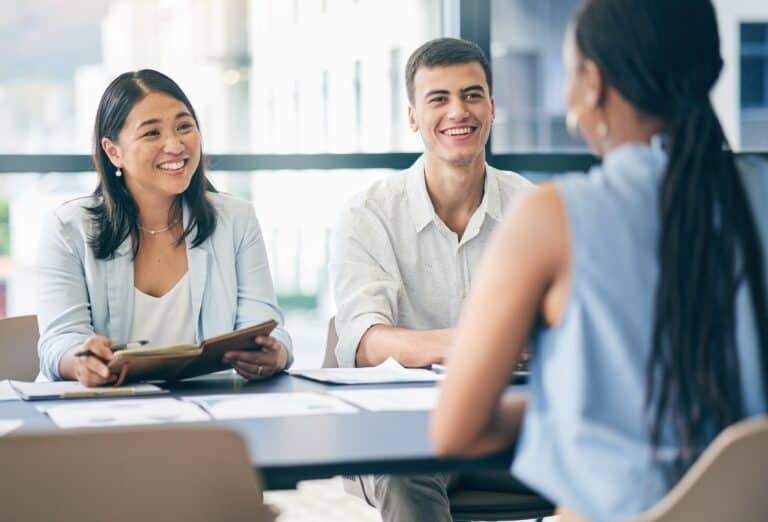 Hiring managers connect with a candidate during a skills-based interview, evaluating real abilities over job titles — a smarter way to build strong teams.