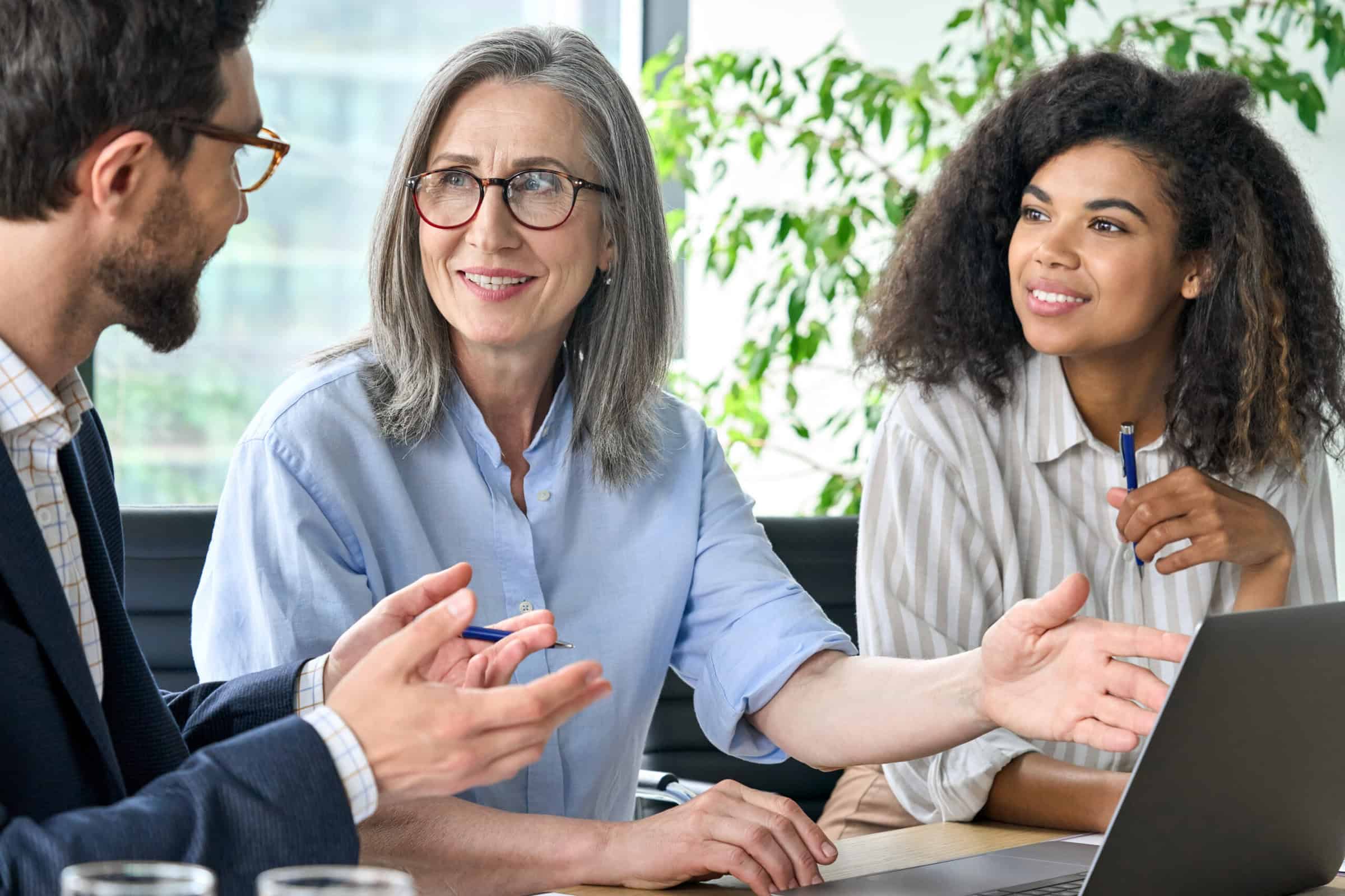 Recruitment team discussing how to use AI in hiring strategies.